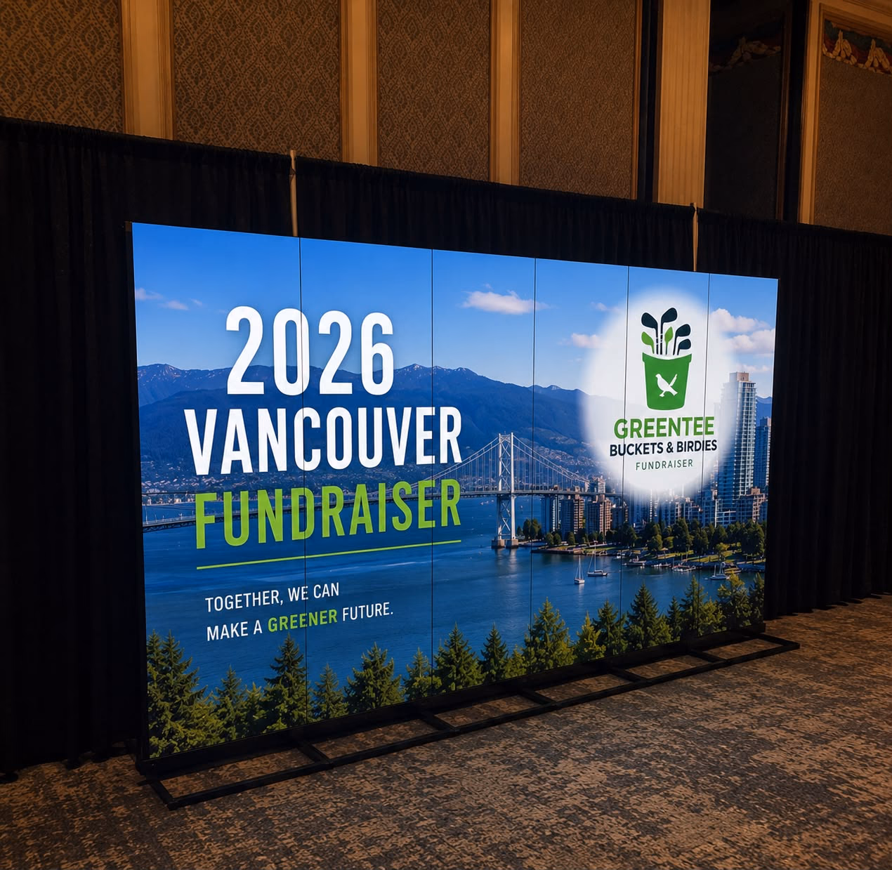 A ballroom backdrop: a seamless LED wall showing "2026 Vancouver Fundraiser" artwork in front of black drapes.